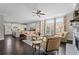 Open concept living room and kitchen featuring a fireplace, large windows, and modern appliances at 103 Brightmoor Ct, Canton, GA 30115