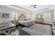 Luxurious bedroom with tray ceilings, a spacious layout, and a seating area at 103 Brightmoor Ct, Canton, GA 30115