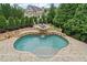 Private outdoor oasis features a custom pool, waterfall, and sundeck at 103 Brightmoor Ct, Canton, GA 30115