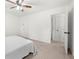 Neutral bedroom featuring a ceiling fan, plush carpeting, and white walls at 245 Amanda Ct, Stockbridge, GA 30281