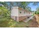 Exterior side view of home featuring vinyl siding and access to basement at 245 Amanda Ct, Stockbridge, GA 30281