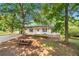 Exterior view of a charming home with mature trees, providing ample shade at 245 Amanda Ct, Stockbridge, GA 30281