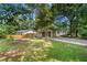 Exterior view of a home showing lawn, landscaping, and covered parking at 245 Amanda Ct, Stockbridge, GA 30281
