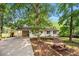 Exterior of home showing covered parking and a picnic bench on the front lawn at 245 Amanda Ct, Stockbridge, GA 30281