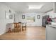 Open floor plan displaying the dining area and white kitchen with stainless steel appliances at 245 Amanda Ct, Stockbridge, GA 30281