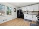 Bright kitchen with white cabinets, stainless steel appliances, and wood-look flooring at 245 Amanda Ct, Stockbridge, GA 30281