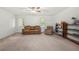 Bright living room features neutral carpet, shelves, a door to the exterior and natural light at 245 Amanda Ct, Stockbridge, GA 30281