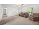 Bright living room with neutral carpet, ceiling fan and natural light at 245 Amanda Ct, Stockbridge, GA 30281