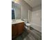 A bathroom featuring a sink and vanity on the left and a tub/shower combo on the right at 2612 Haligan Pt, Riverdale, GA 30296