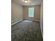 Bedroom with a bright window, neutral paint, new carpet and natural light at 2612 Haligan Pt, Riverdale, GA 30296