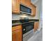 Modern kitchen with stainless steel oven and microwave, complemented by wooden cabinets at 2612 Haligan Pt, Riverdale, GA 30296