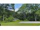Scenic backyard with dense trees, complemented by a gravel pad, offering privacy and a natural setting at 2647 Old Snapping Shoals Rd, Mcdonough, GA 30252
