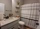 Neutral bathroom features granite counter, white cabinets, and shower with striped curtain at 2647 Old Snapping Shoals Rd, Mcdonough, GA 30252