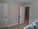 Neutral bedroom featuring carpet flooring, base molding, and a view to the upstairs hallway at 2647 Old Snapping Shoals Rd, Mcdonough, GA 30252