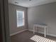 Bedroom featuring a window with blinds and white base molding at 2647 Old Snapping Shoals Rd, Mcdonough, GA 30252