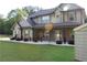 Beautifully landscaped two-story home with stone column accents and gray shutters at 2647 Old Snapping Shoals Rd, Mcdonough, GA 30252