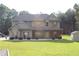 Two-story home with wood shutters and stone accents at 2647 Old Snapping Shoals Rd, Mcdonough, GA 30252