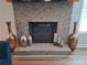Cozy brick fireplace is flanked by decorative vases at 2647 Old Snapping Shoals Rd, Mcdonough, GA 30252