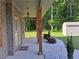 Inviting front porch with brick accents, wooden support beams, and manicured landscaping at 2647 Old Snapping Shoals Rd, Mcdonough, GA 30252