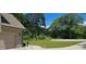 Lush front yard featuring a driveway leading to the garage and meticulously maintained landscaping at 2647 Old Snapping Shoals Rd, Mcdonough, GA 30252