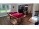 Sun-drenched game room boasts a pool table, hardwood floors, and an adjacent living room at 2647 Old Snapping Shoals Rd, Mcdonough, GA 30252