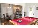 Bright game room features a pool table, hardwood floors, and an adjacent dining area and kitchen at 2647 Old Snapping Shoals Rd, Mcdonough, GA 30252