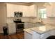 Bright kitchen featuring stainless steel appliances, white cabinets, and granite countertops at 2647 Old Snapping Shoals Rd, Mcdonough, GA 30252