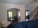 Open-concept living area with wood floors, staircase, and natural light at 2647 Old Snapping Shoals Rd, Mcdonough, GA 30252