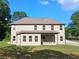 Back of home featuring a covered patio, large windows and plenty of room to enjoy the outdoors at 2647 Old Snapping Shoals Rd, Mcdonough, GA 30252