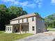 Rear view of the house with a covered patio, outdoor seating, and spacious backyard at 2647 Old Snapping Shoals Rd, Mcdonough, GA 30252