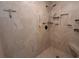 Modern shower features tiled walls, recessed shelving, and a rain shower head at 2647 Old Snapping Shoals Rd, Mcdonough, GA 30252
