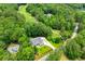 Aerial view of home near golf course, surrounded by trees and lush landscaping at 7037 Tara Dr, Villa Rica, GA 30180