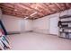 Unfinished basement featuring exposed ceiling beams and concrete walls at 7037 Tara Dr, Villa Rica, GA 30180