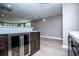 Finished basement with wet bar featuring modern cabinets, stainless refrigerator, and stone countertops at 7037 Tara Dr, Villa Rica, GA 30180