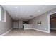 Finished basement featuring light wood-look flooring, recessed lighting, and a bar area with modern cabinets at 7037 Tara Dr, Villa Rica, GA 30180