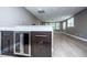 Finished basement with wet bar featuring wood cabinets, stainless refrigerator, and view of recreation space at 7037 Tara Dr, Villa Rica, GA 30180