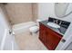 Bathroom featuring a wooden vanity, black countertop, bathtub, shower and toilet at 7037 Tara Dr, Villa Rica, GA 30180