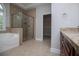 Well-lit bathroom featuring a glass shower and a separate tub at 7037 Tara Dr, Villa Rica, GA 30180