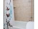 Full bathroom with tile walls and shower curtain at 7037 Tara Dr, Villa Rica, GA 30180