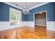 Elegant dining room featuring hardwood floors, large window and stunning chandelier at 7037 Tara Dr, Villa Rica, GA 30180