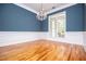 Bright dining room featuring hardwood floors, blue walls, and large windows at 7037 Tara Dr, Villa Rica, GA 30180