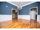 Elegant dining room with hardwood floors, blue walls, and stylish chandelier at 7037 Tara Dr, Villa Rica, GA 30180