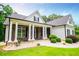 This beautiful home offers a stone facade, a covered porch with stately columns, and a sprawling green lawn at 7037 Tara Dr, Villa Rica, GA 30180