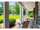 This covered front porch features stately columns, stone accents, and wooded views at 7037 Tara Dr, Villa Rica, GA 30180