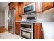 Updated kitchen with stainless steel appliances, wood cabinets, and tile flooring at 7037 Tara Dr, Villa Rica, GA 30180