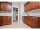 Spacious kitchen with stainless steel appliances, tiled floors, and rich wood cabinetry at 7037 Tara Dr, Villa Rica, GA 30180