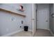 Functional laundry room with tile floors and ample storage space at 7037 Tara Dr, Villa Rica, GA 30180