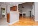 Open concept showcasing a fireplace, hardwood floors, and a kitchen breakfast bar at 7037 Tara Dr, Villa Rica, GA 30180
