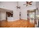 Open living room featuring hardwood floors, a fireplace, and a view into the kitchen at 7037 Tara Dr, Villa Rica, GA 30180