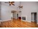 Spacious living room with hardwood floors, high ceilings, fireplace, and fan at 7037 Tara Dr, Villa Rica, GA 30180